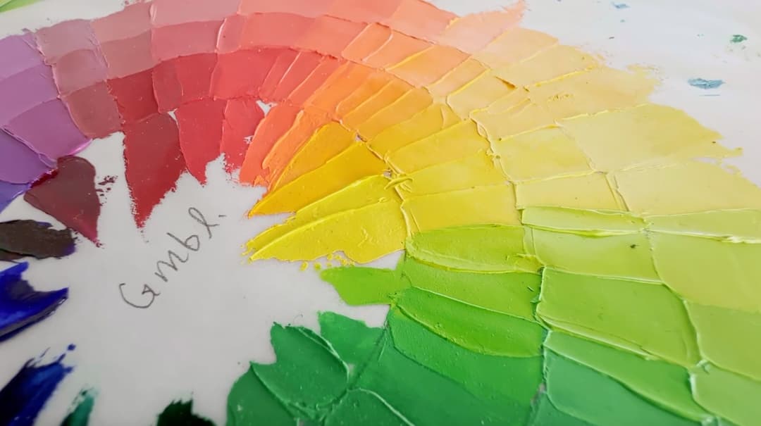 A closeup of paints swatched with a palette knife to show how it makes ridges.