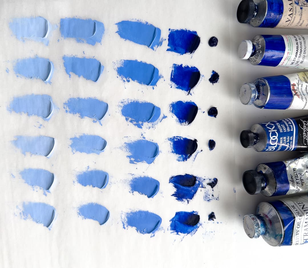 Six versions of ultramarine showing the paint at full strength, then three levels of tint with Titanium White.